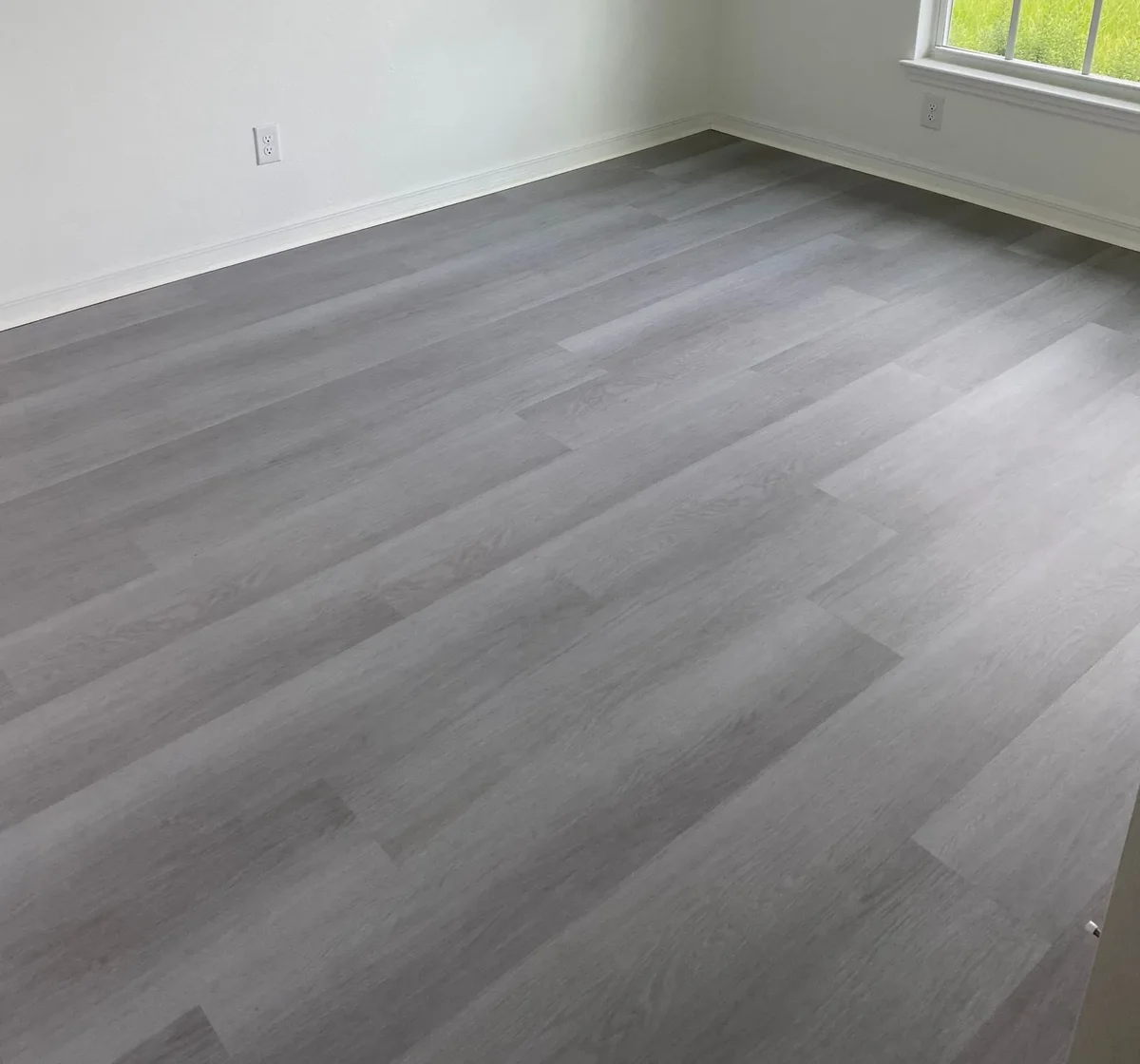 Grey oak luxury vinyl plank laid wall-to-wall in a Southwest Florida room