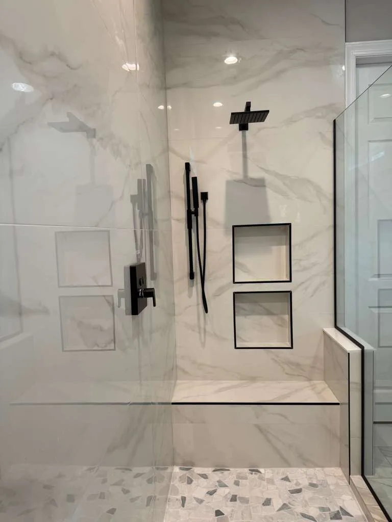 Marble-look walk-in shower with frameless glass, Naples luxury remodel