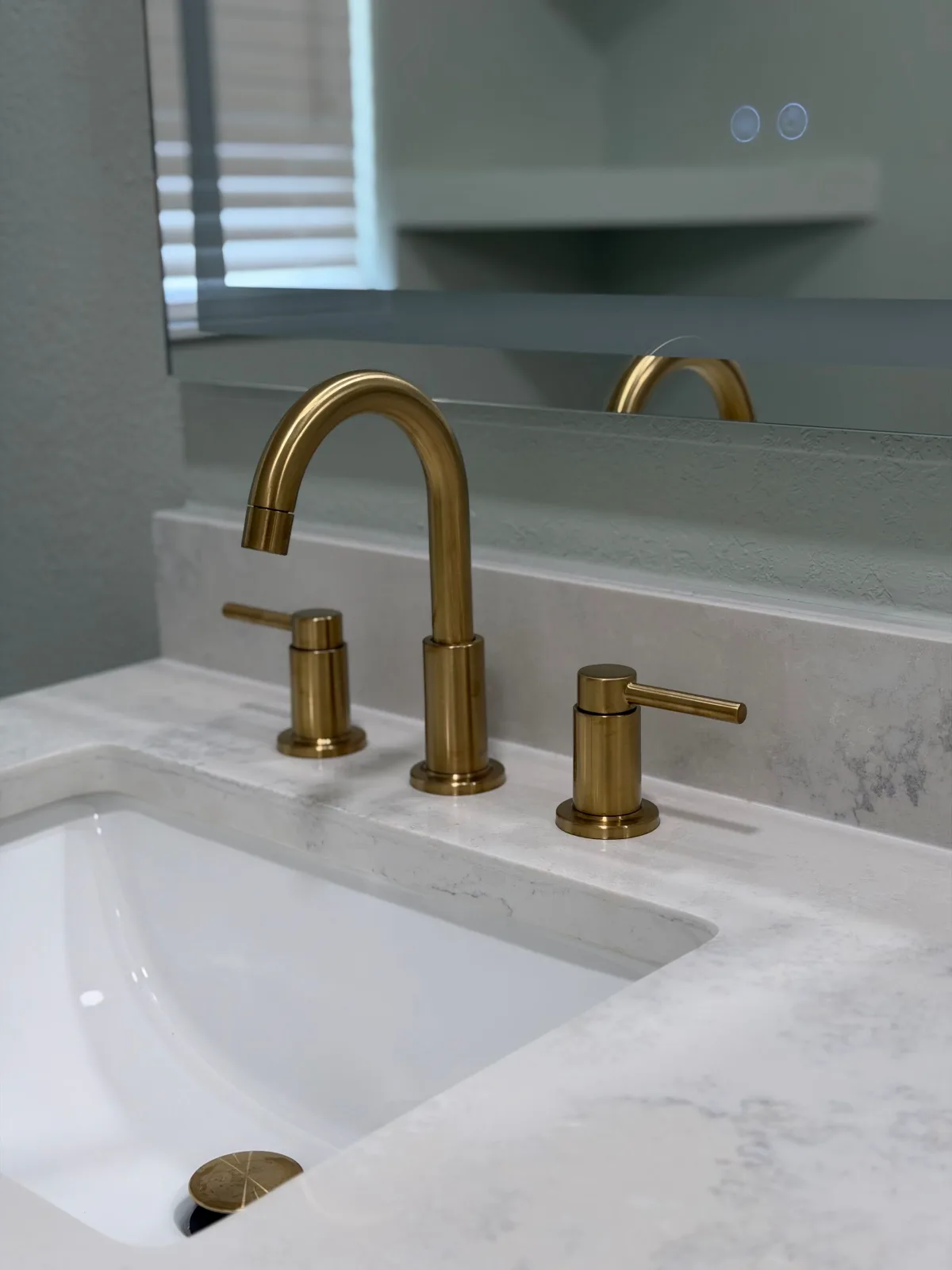 Quartz vanity top with undermount sink and brushed gold widespread faucet