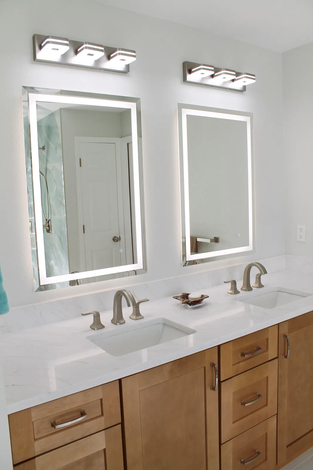 Double vanity with LED mirrors, quartz counter, and brushed nickel faucets