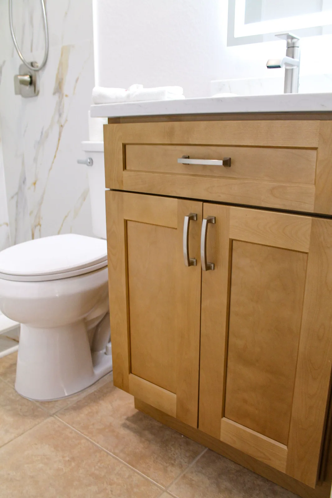 Honey oak shaker vanity in a remodeled guest bathroom