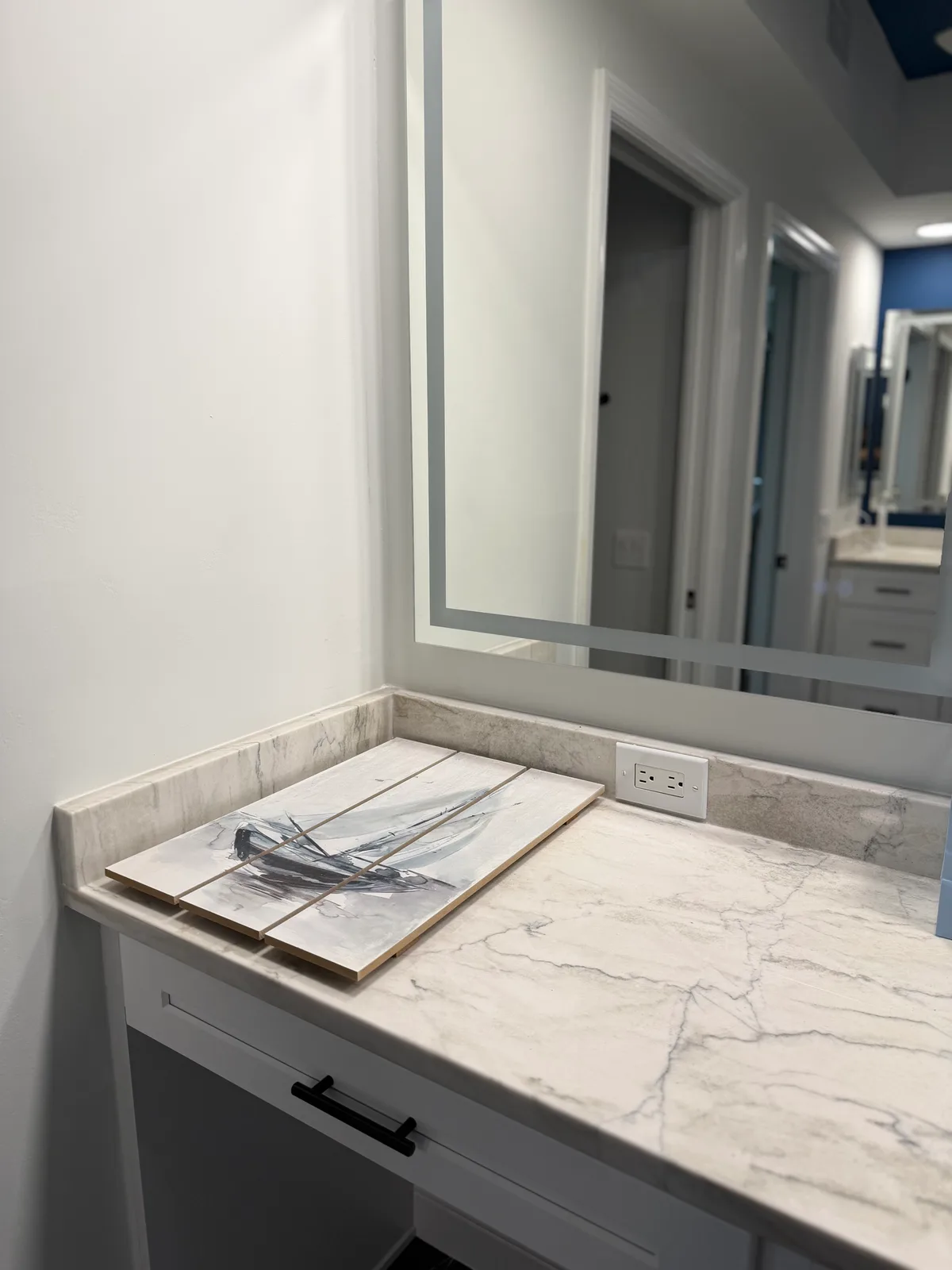 Quartz makeup ledge beside the vanity with an LED mirror, Naples master bathroom