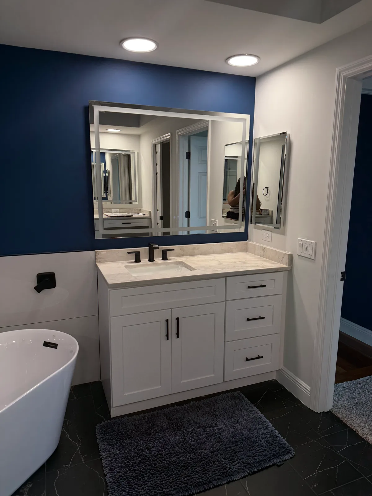White shaker vanity with a black-framed mirror and a matte black faucet, Naples