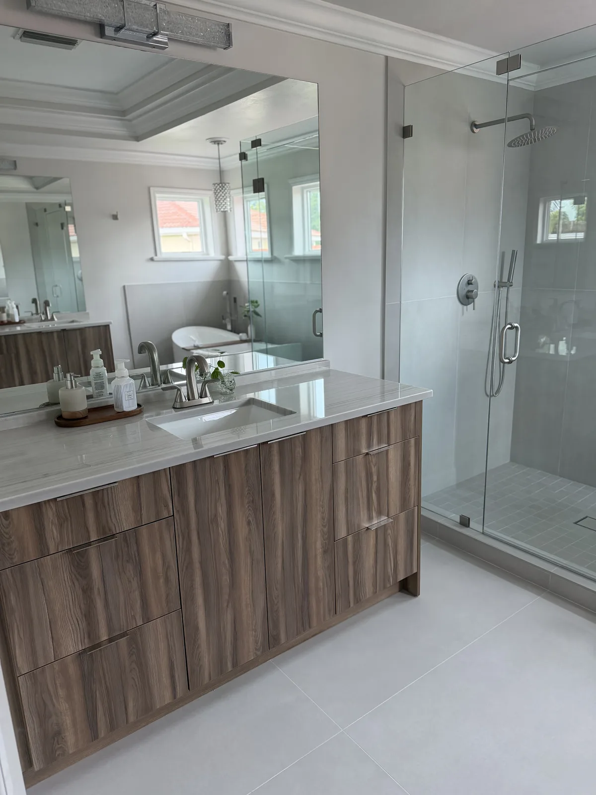 Vanity and full mirror wall facing a walk-in shower, Fort Myers master bath