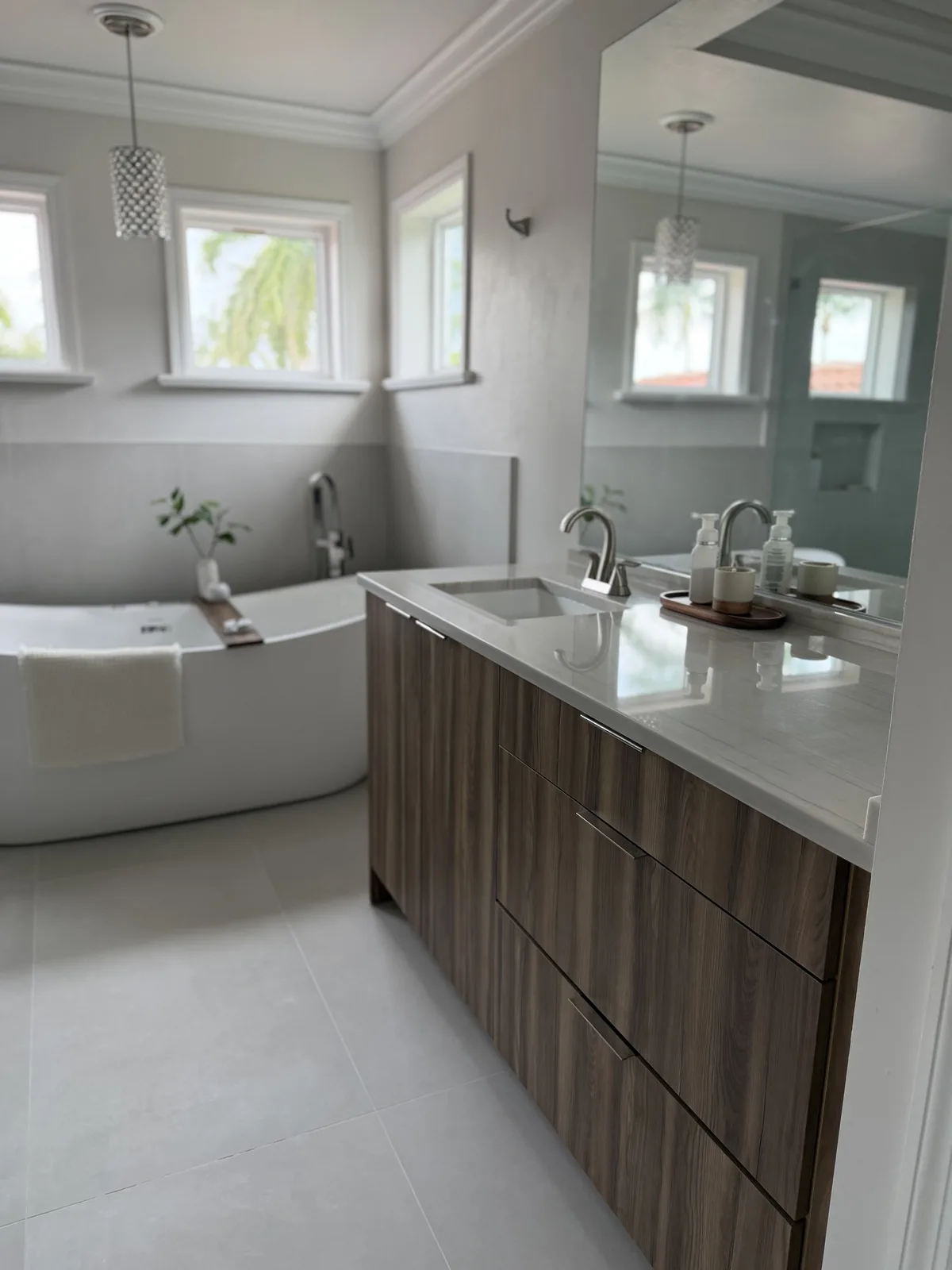 Freestanding tub and walnut vanity in a Fort Myers master bathroom