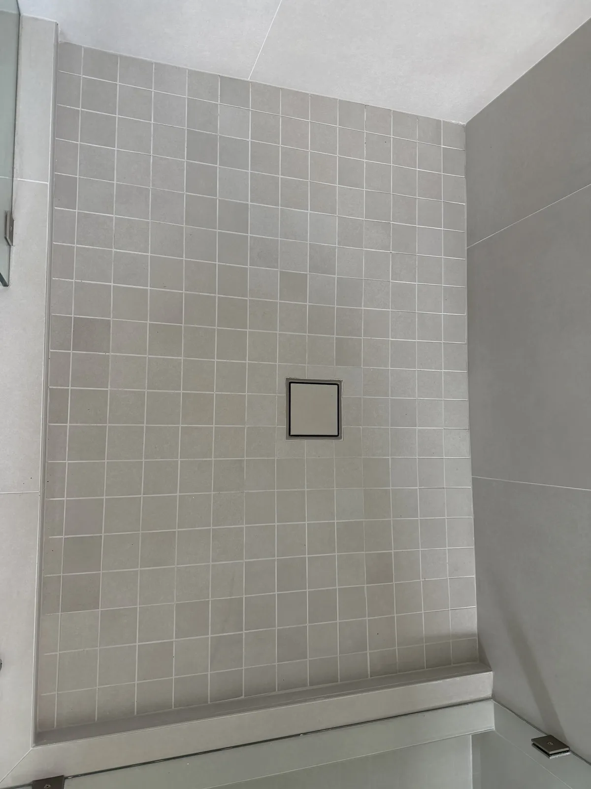 Mosaic shower floor with a square centre drain in a Fort Myers walk-in shower