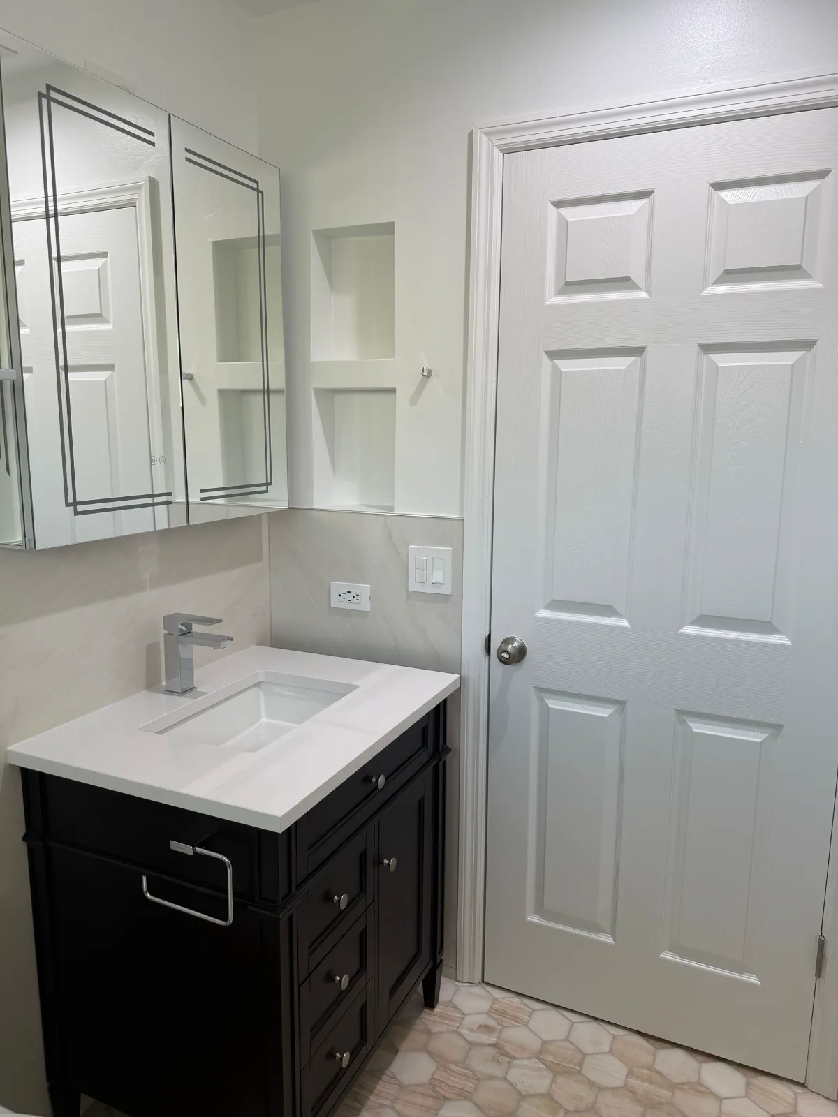 Espresso vanity with LED mirror in a remodeled hall bathroom