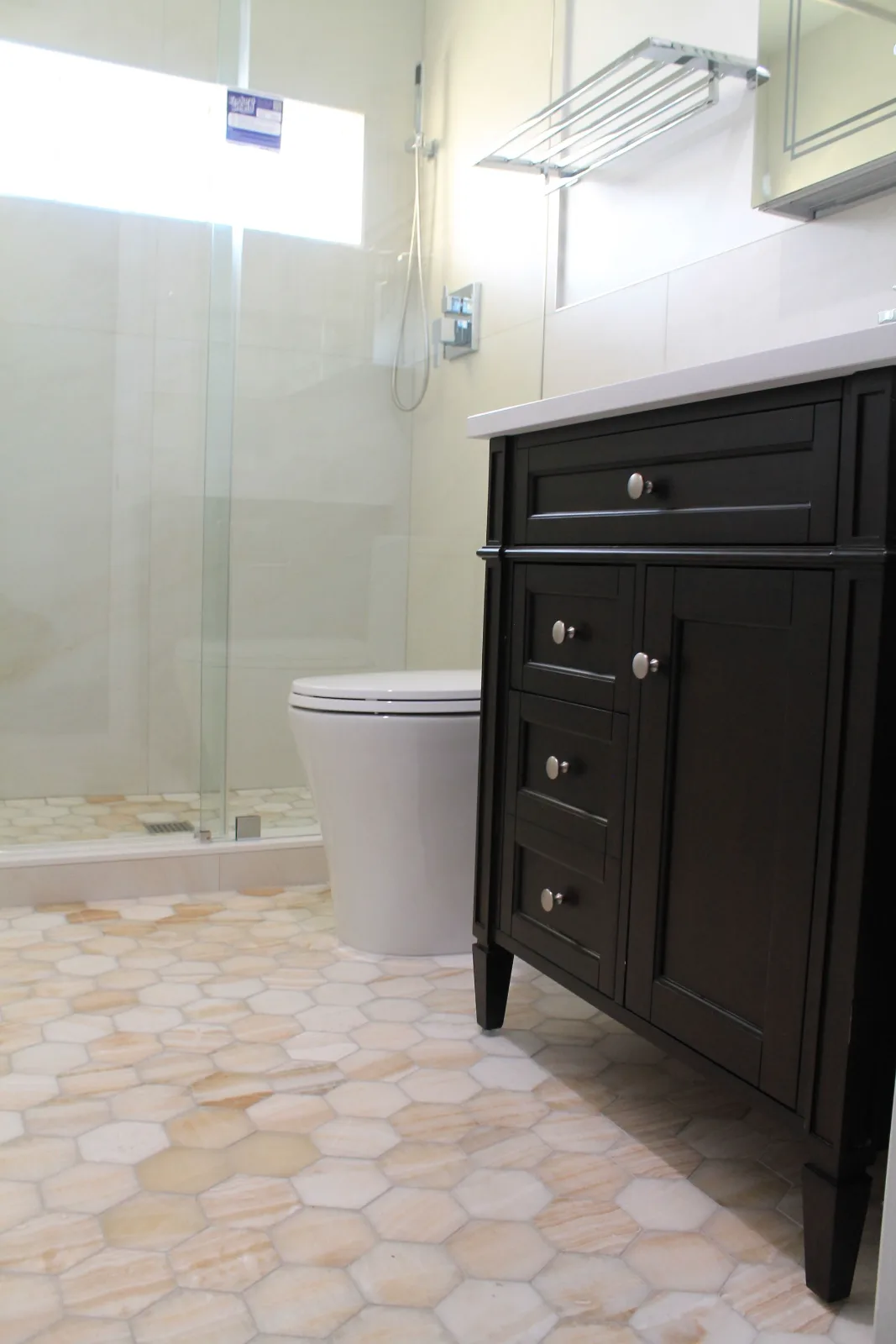Espresso shaker vanity on honey onyx hexagon mosaic tile floor
