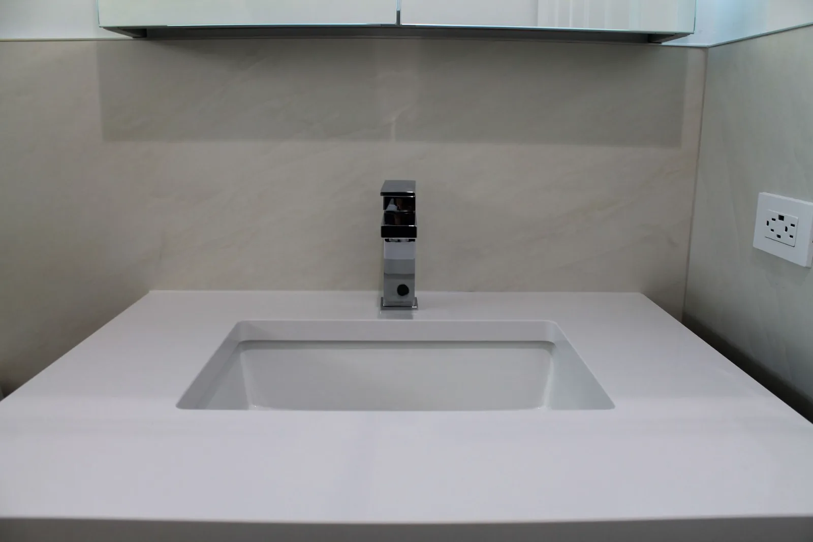Floating white quartz vanity top with undermount sink and chrome faucet